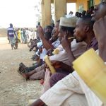 Football spectators snacking on sugarcane at San Siro Stadium, Kaduna, Nigeria, Digital photograph, Ishaq Mohammed Bello